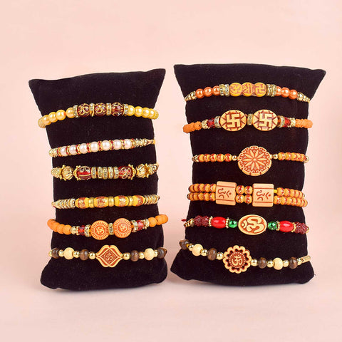 Assortment of 12 Rakhis, featuring different designs, threads, and embellishments for Raksha Bandhan. India’s Largest Pooja Accessories Brand - www.satvikstore.in